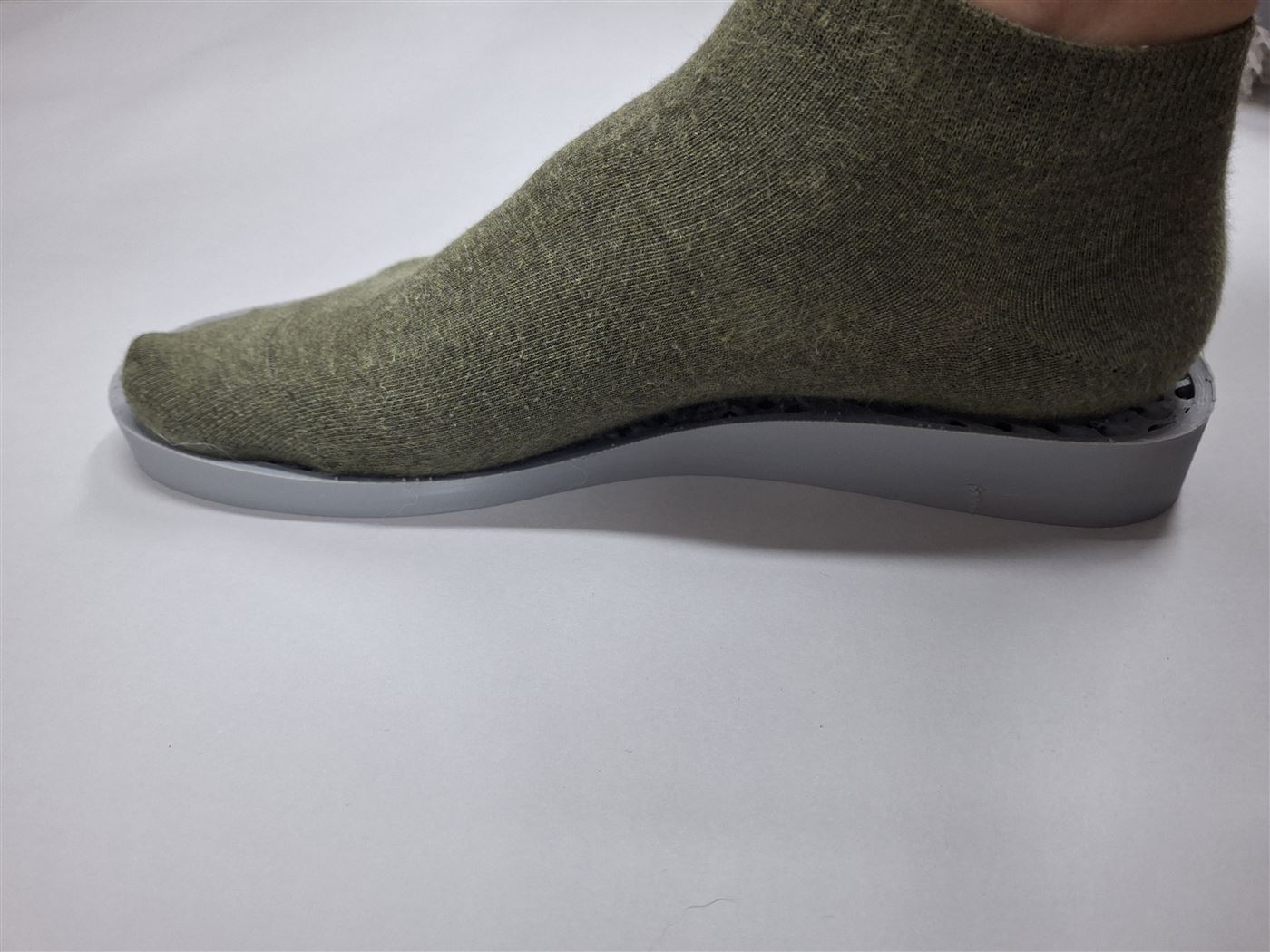 Foot standing on the prototype insole